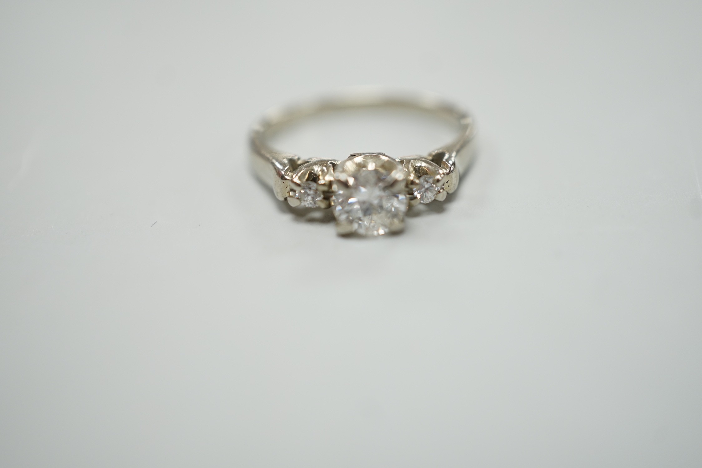 A Canadian Birks 18k white metal and single stone diamond ring, with diamond set shoulders, size H, gross weight 2.7 grams